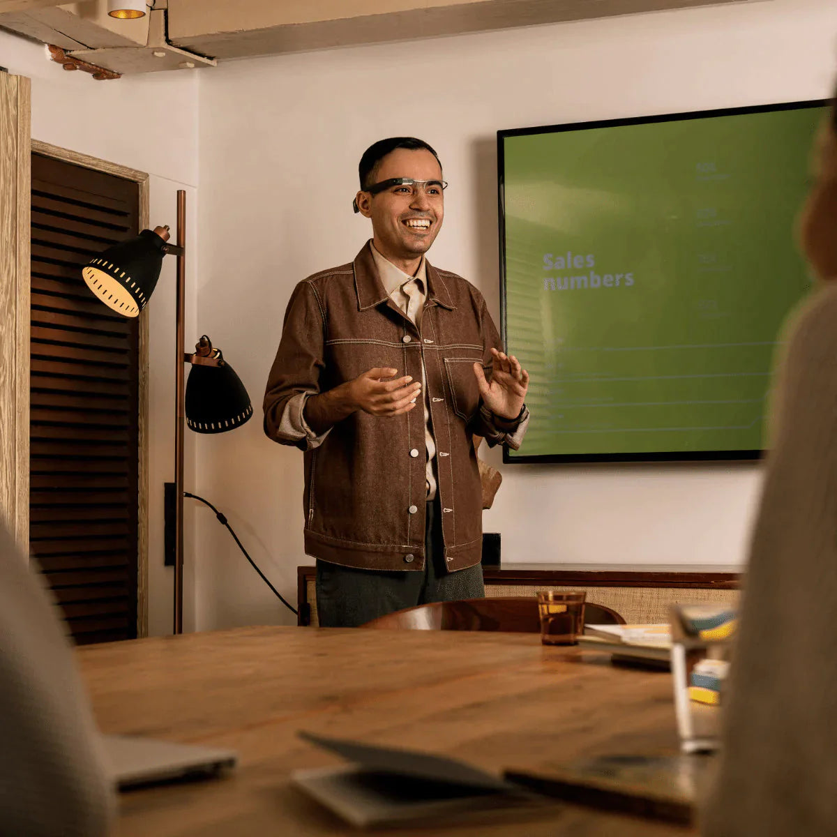 Man giving presentation while wearing Envision Glasses with Standard Titanium Frames