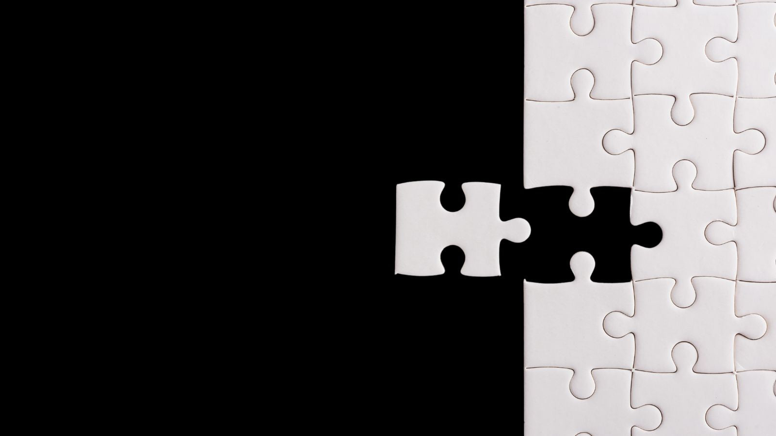 a puzzle with the last piece about to be inserted